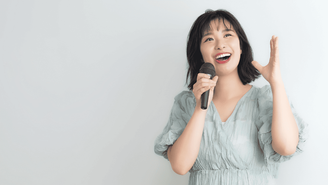 マイクを持って歌い上げる女性